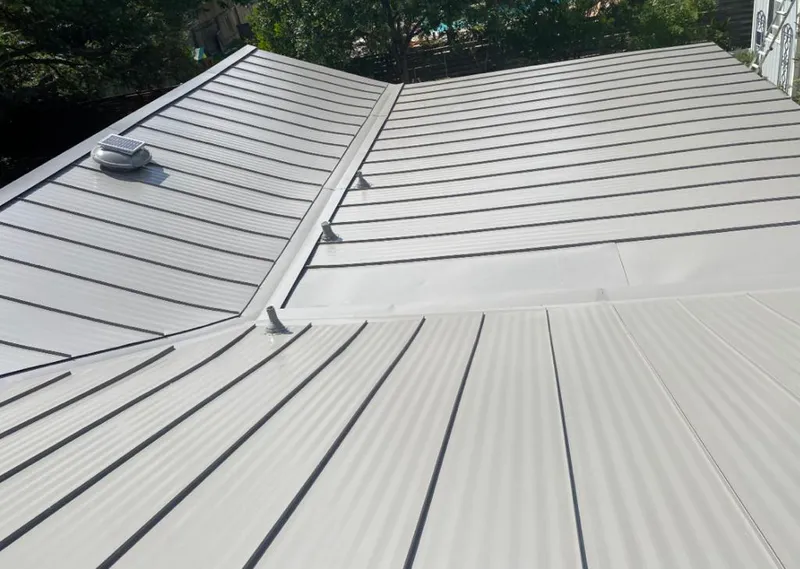 Solar attic fan installed on a metal roof for Roof Ventilation in Lauderdale-by-the-Sea